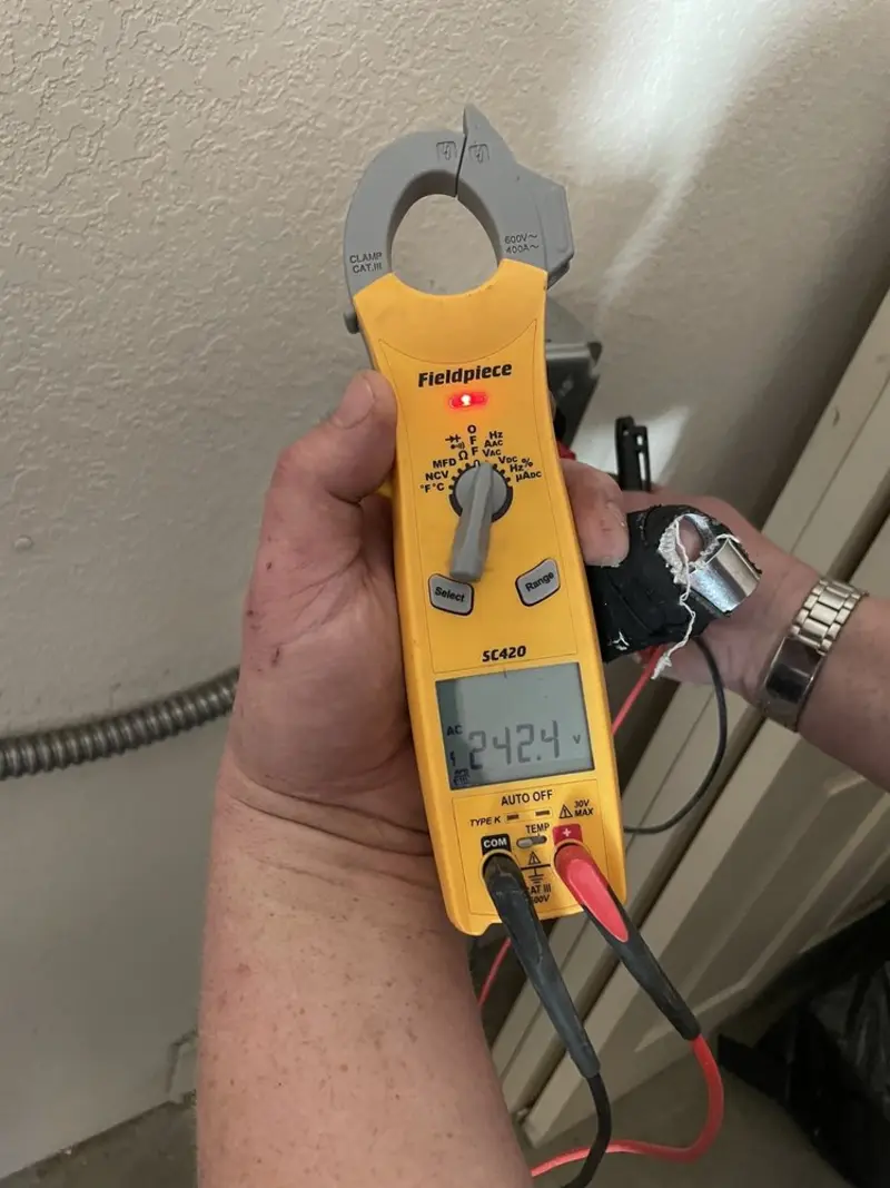 Voltage testing with clamp meter during Electrical Installation Services in Ponca City